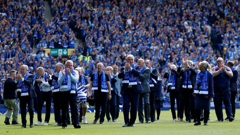 Former players flood the pitch. Pic: Reuters
