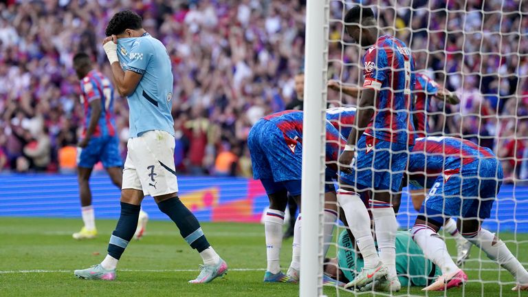 Manchester City's Omar Marmoush (left) reacts after having his penalty saved as Crystal Palace goalkeeper Dean Henderson is mobbed by his team mates during the Emirates FA Cup final at Wembley Stadium, London. Picture date: Saturday May 17, 2025. Pic: PA 