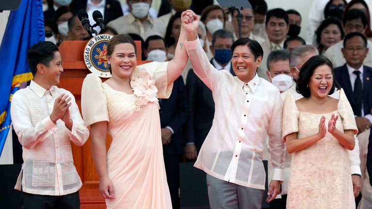 FILE - President Ferdinand Marcos Jr., center right, and Philippine Vice President Sara Duterte, daughter of former Philippine President Rodrigo Duterte, greet during the inauguration ceremony at National Museum on June 30, 2022 in Manila, Philippines. (AP Photo/Aaron Favila, file)