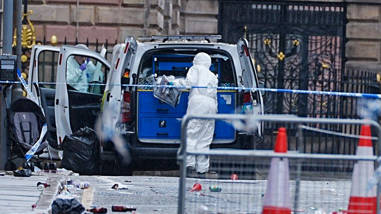 Forensic officers at the scene in Water Street.
Pic: PA
