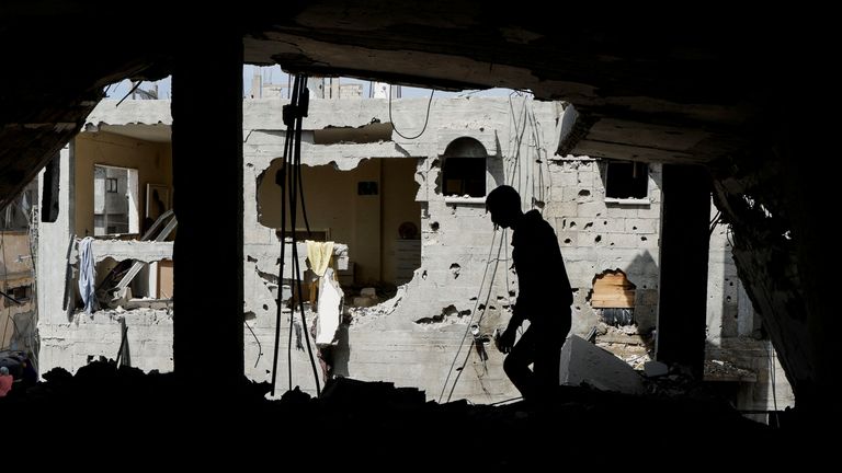 A Palestinian man inspects the house where Palestinian newlywed Hala Zaarab was killed in an Israeli airstrike, in Khan Younis, Gaza.
Pic: Reuters