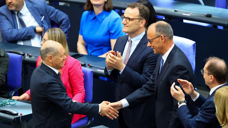 Germany's incoming Chancellor Friedrich Merz shakes hands with outgoing German Chancellor Olaf Scholz.
Pic Reuters