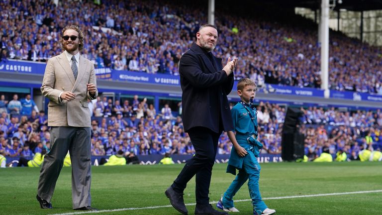 Former Everton manager Wayne Rooney walk out onto the pitch with his son Cass after full-time. Pic: PA