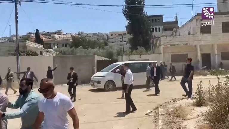 Members of the delegation flee as gunshots are fired