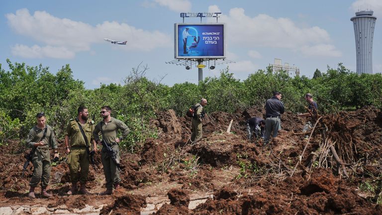 Israeli forces inspect the site where a Yemeni missile landed near the Ben Gurion International Airport.
Pic: AP/Ohad Zwigenberg