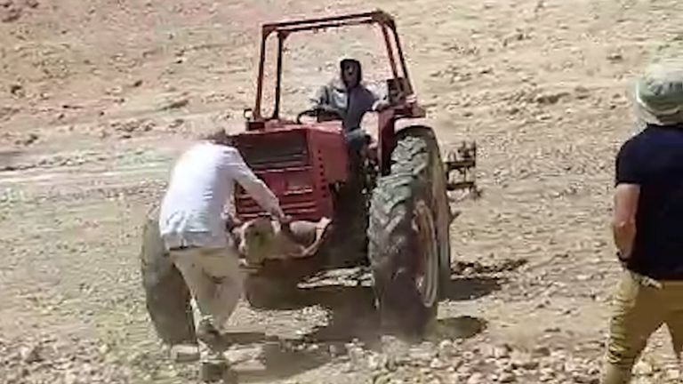 Footage captured by Rachel Abramovitz, a member of the group Looking the Occupation in the Eye, shows activists trying to block settlers from seizing control of the village center.

