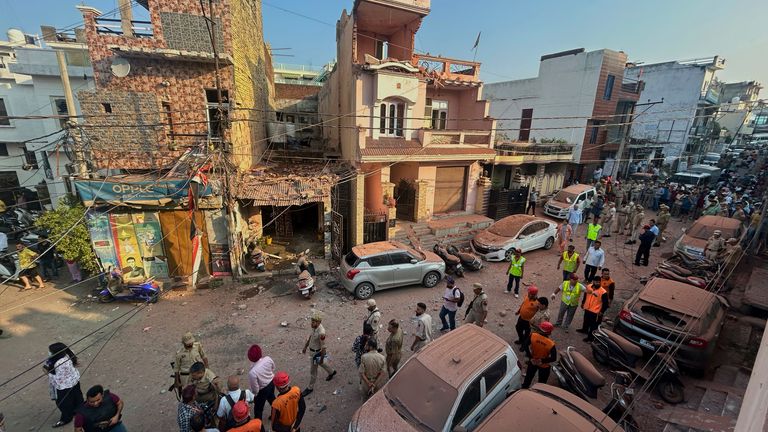 Rescuers and security personnel inspect a residential building damaged by a Pakistan's drone attack in Jammu, India, Saturday, May 10, 2025. (AP Photo/Channi Anand)