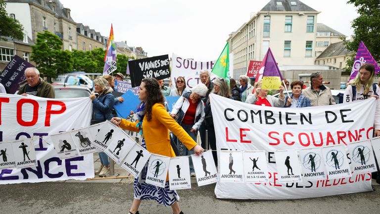 Demonstrators hold posters.
Pic: AP