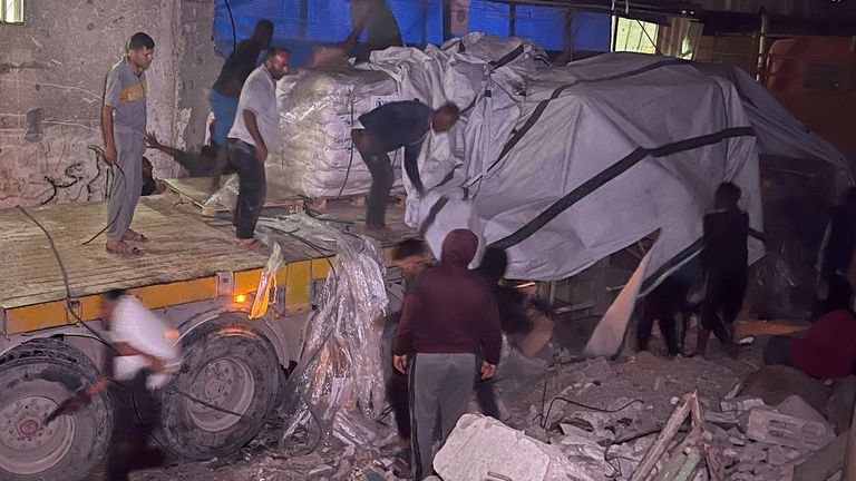 Palestinian workers unload an aid truck, in Khan Younis. Pic: Reuters