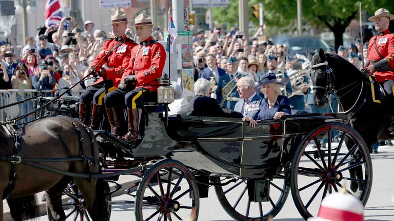 King Charles and Queen Camilla ride in a horse-drawn landau, accompanied by the Royal Canadian Mounted Police.
Pic: Reuters
