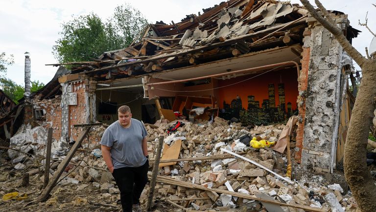 Resident Vadym Tysbenko, 22, outside his drone-struck house outside Kyiv. Pic: Reuters