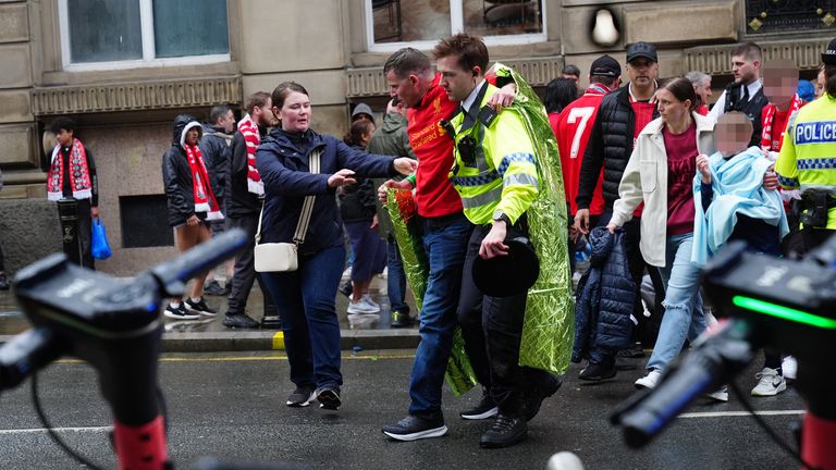 EDITORS NOTE: Children's faces have been pixelated as the PA Picture Desk has been unable to gain the necessary permission to photograph a child under 16 on issues involving their welfare. Police and emergency personnel dealing with an incident near the Liver Building in Liverpool during the Premier League winners parade. Picture date: Monday May 26, 2025.