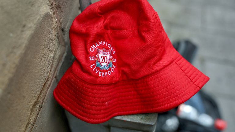 A Liverpool football club hat is left behind near the scene in the aftermath of an incident where a car plowed into a crowd of Liverpool fans during a parade celebrating their side's Premier League soccer title, in central Liverpool, Britain, May 28, 2025. REUTERS/Isabel Infantes 
