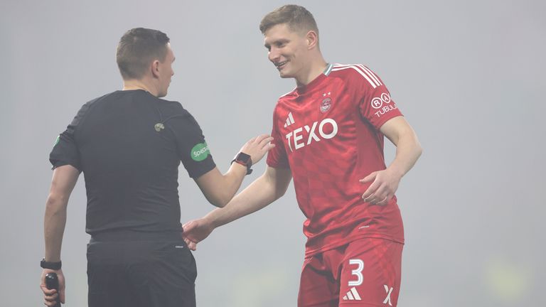 Aberdeen's Jack Mackenzie (right) speaks with one of the assistant referees during the Viaplay Cup semi final match at Hampden Park, Glasgow. Picture date: Saturday November 2, 2024. Steve Welsh/PA Wire
