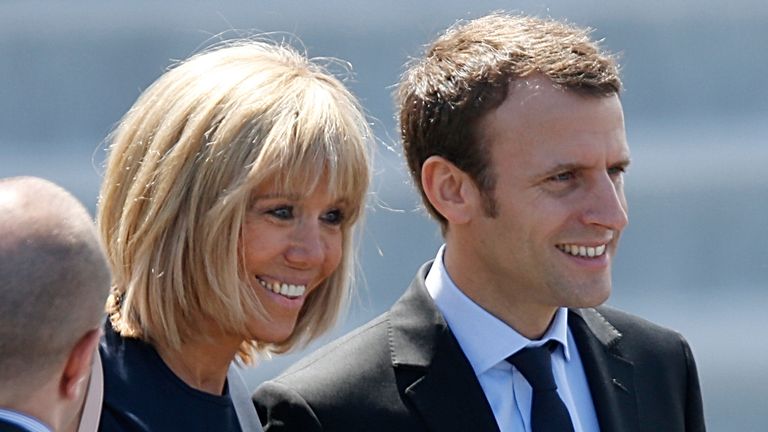 French Economy Minister Emmanuel Macron (R) and his wife Brigitte Trogneux attend the Bastille Day military parade on the Champs-Elysees in Paris, France, July 14, 2016. REUTERS/Charles Platiau