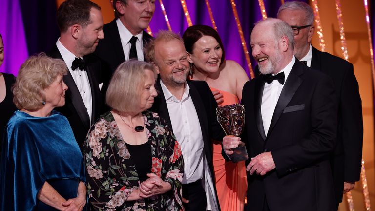 Toby Jones, Monica Dolan and Sir Alan Bates on stage with the limited drama award for Mr Bates Vs The Post Office. Pic: John Phillips/ Getty Images for BAFTA