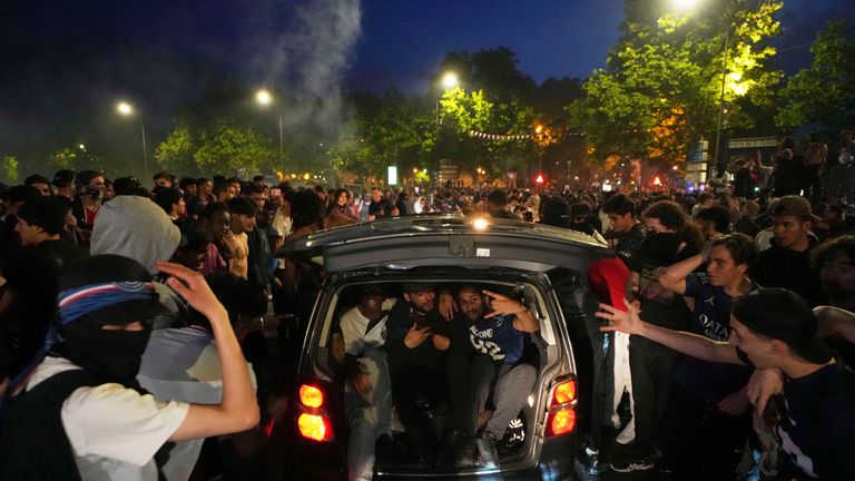 PSG supporters invade a street in Paris after the team won the Champions League. Pic: AP