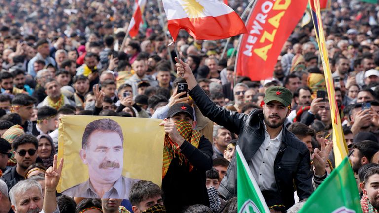  A person holds a flag with an image of jailed Kurdish militant leader Abdullah Ocalan during a gathering to celebrate the spring festival of Newroz in Istanbul, Turkey, March 23, 2025. REUTERS/Tolga Uluturk/File Photo

