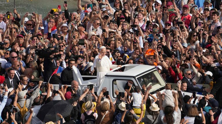 Pope Leo waves from the popemobile. Pic: AP