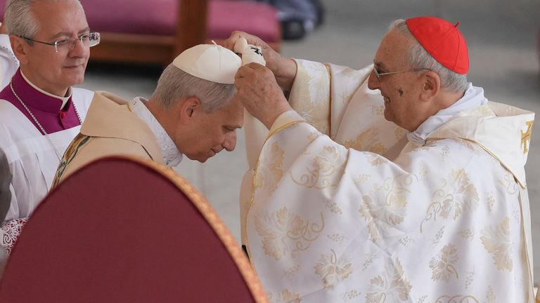 The pope receives the lambswool stole, a symbol of the papacy, during the inauguration. Pic: AP