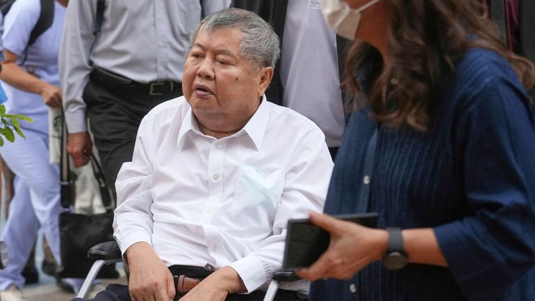 Premchai Karnasuta, the president of Italian-Thai Development Co arrives on a wheelchair at Bang Sue Police Station in Bangkok, Thailand, Friday, May 16, 2025 to surrender to police on criminal negligence charges for the collapse of a Bangkok high-rise during a March 28 earthquake. (AP Photo/Sakchai Lalit)