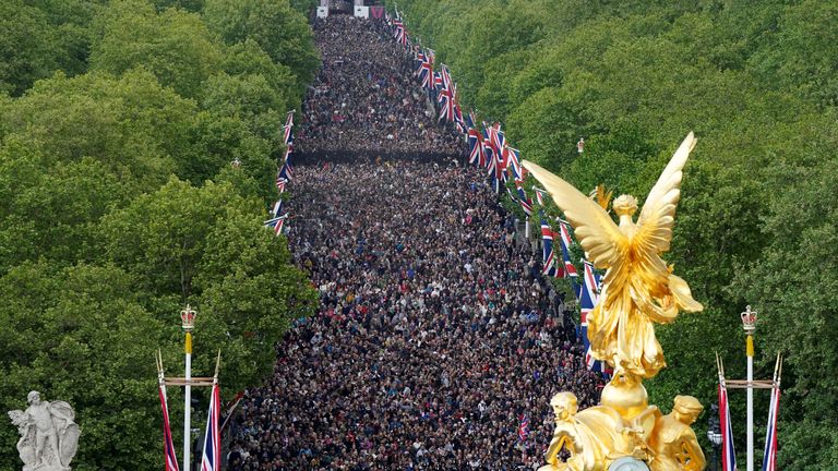 Members of the public walk up The Mall, near Buckingham Palace in central London, following a military procession marking the 80th anniversary of VE Day, and in honour of those who served during the Second World War, in central London. Picture date: Monday May 5, 2025. Andrew Matthews/Pool via REUTERS
