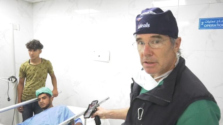 Dr Tom Potokar with a patient at the Amal hospital