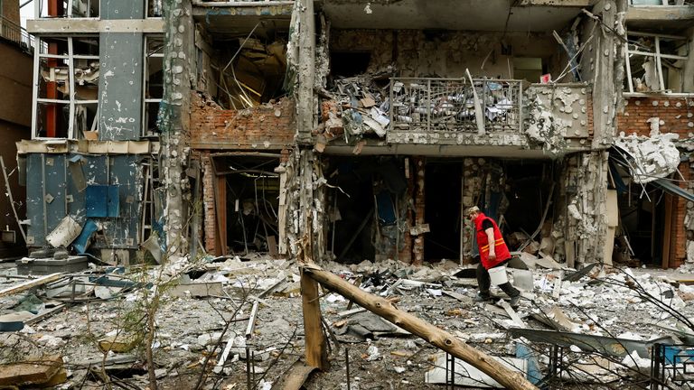 A municipality worker cleans up after a Russian drone strike on Kyiv.
Pic: Reuters