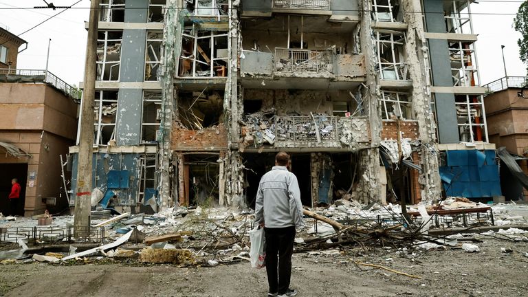 A resident looks at an apartment building that was damaged in a Russian drone strike.
Pic: Reuters