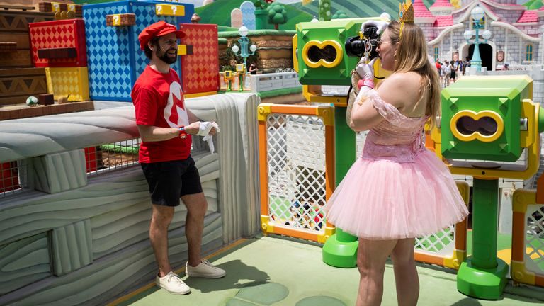 A man wears a Mario costume as he poses for a photo at "Super Nintendo World" world in Universal Epic Universe theme park ahead of the grand opening ceremony in Orlando, Florida, U.S. May 20, 2025. REUTERS/Marco Bello/File Photo