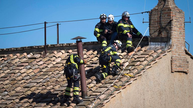 Italian firefighters install a temporary chimney on the roof of the Sistine Chapel at the Vatican, which will release smoke signalsblack or whitefrom the upcoming conclave starting May 7, indicating whether a new pope has been elected. Vatican Media /Spaziani Photo by: Vatican Media /Spaziani/picture-alliance/dpa/AP Images