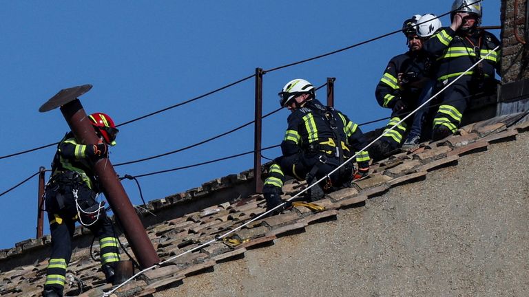 Members of the fire and rescue service set a chimney on the roof of the Sistine Chapel, ahead of the conclave, at the Vatican.
Pic: Reuters