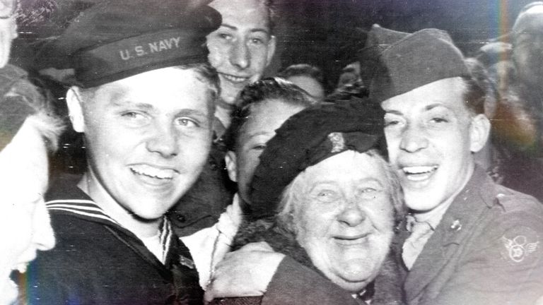 An elderly woman gets a hug from a sailor in London on VE Day. Pic: AP