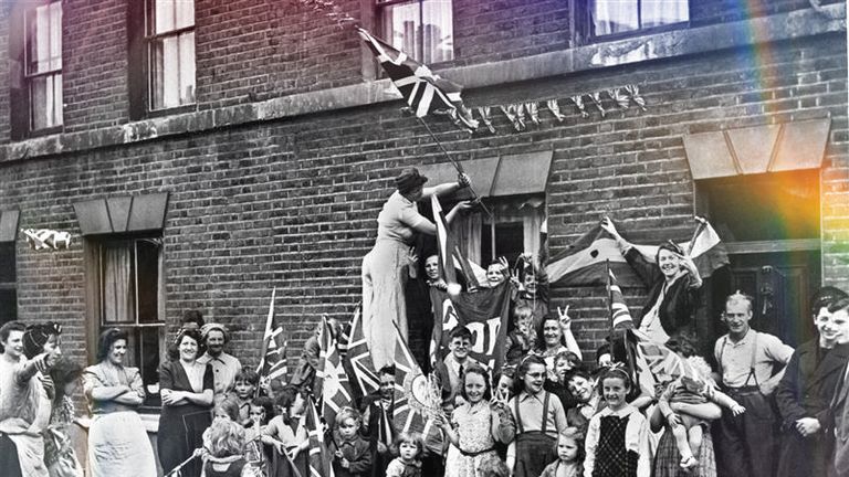 Families fly flags and bunting in the street. Pic: PA