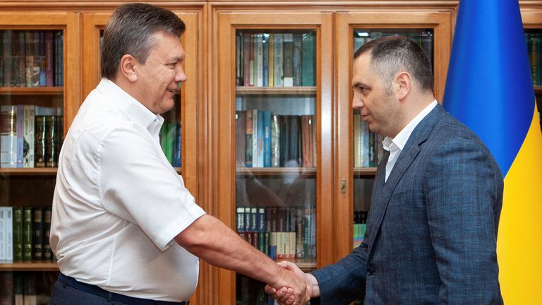 Viktor Yanukovych and Andriy Portnov shake hands in Kyiv.
Pic: Reuters