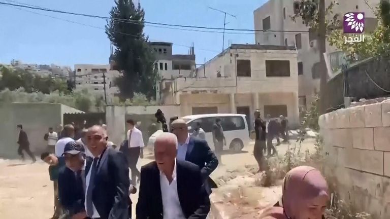 Members of the delegation flee as gunshots are fired