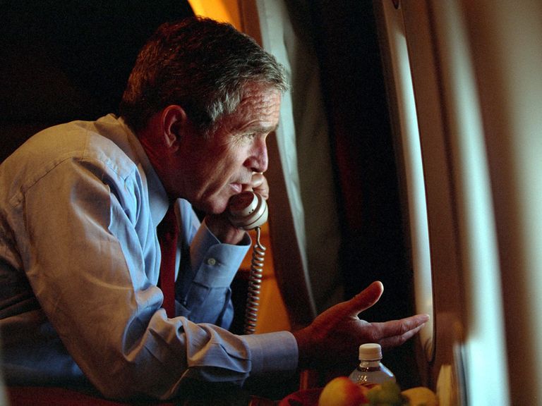 U.S. President George W. Bush speaks to Vice President Dick Cheney by phone aboard Air Force One after departing Offutt Air Force Base in Nebraska, September 11, 2001, on the day of the terror attacks in New York and Washington. Bush on September 16, 2001 asked "horrified" Americans to go back to work this week, cautioning them to be alert for more attacks and to brace for a long crusade to "rid the world of evildoers". Picture released by the White House on September 16. REUTERS/WHITE HOUSE pho