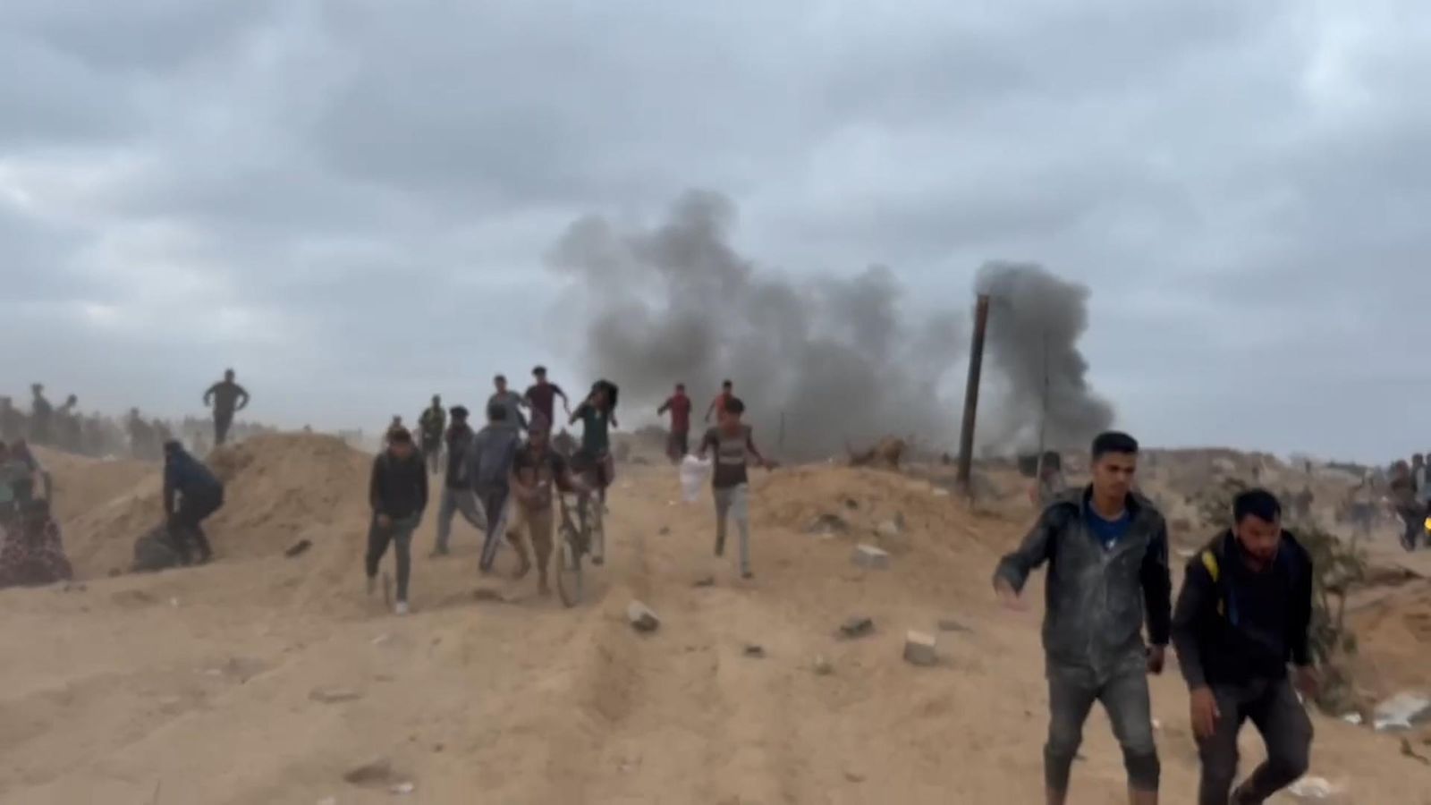 Israel accused of firing at crowds near Gaza aid centre as UK sanctions ...