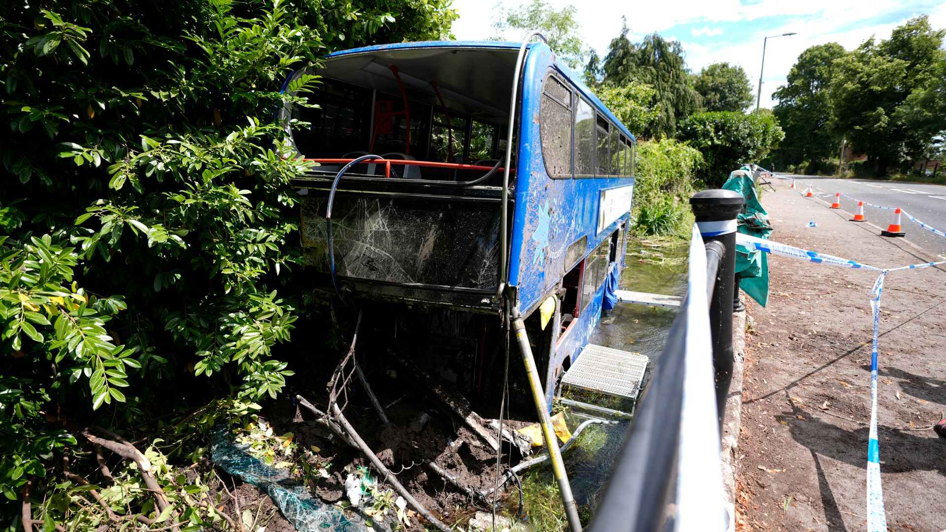 Five people taken to hospital after double-decker bus carrying students crashes into river