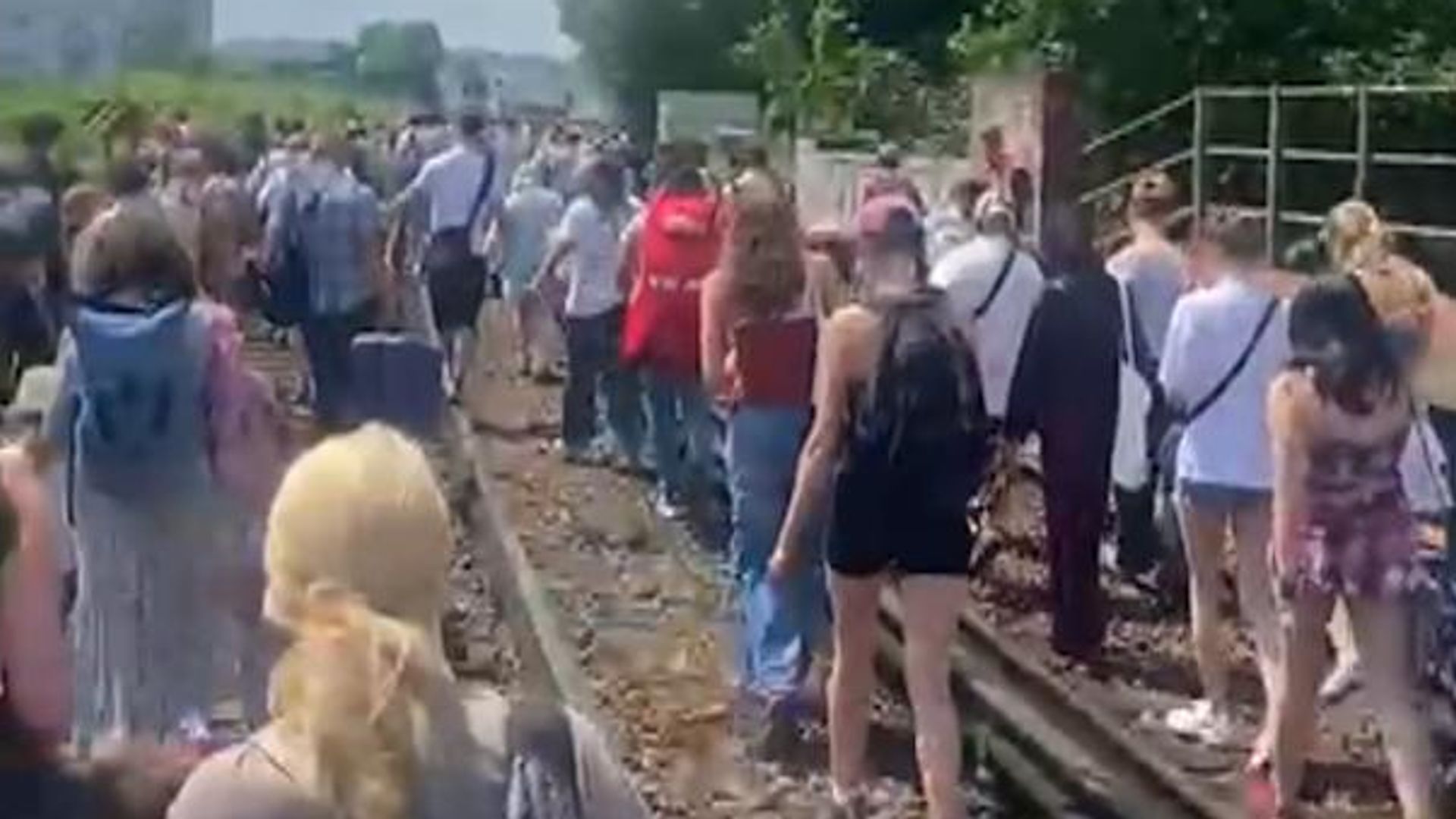 Rail passengers have to walk along tracks on hottest day of year after fault brings trains to halt