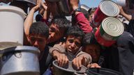 Palestinians struggle to get donated food at a community kitchen in Khan Younis on Monday. Pic: AP