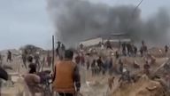 Palestinians run from explosions as they made their way to a food distribution centre