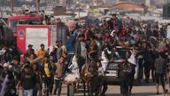 Palestinians carry humanitarian aid packages delivered by the Gaza Humanitarian Foundation in Khan Younis. Pic: AP