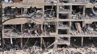 Rescue workers inspect the site of an Iranian missile strike in Tel Aviv, Israel on Sunday. Pic: AP
