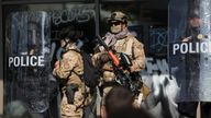 Members of law enforcement stand guard in downtown LA. Pic: Reuters/Leah Mills