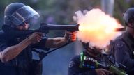 A police officer fires a soft round in Los Angeles. Pic: AP Photo/Eric Thayer
