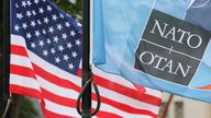 NATO and U.S. flags fly at the entrance to the venue, on the first day of a NATO summit, in The Hague, Netherlands June 24, 2025. REUTERS/To