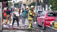 Firefighters and people clean up the scene of an explosion at a residence compound after Israeli attacks in Tehran.
Pic: AP