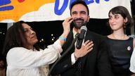Zohran Mamdani reacts next to his mother Mira Nair and wife Rama Duwaji.
Pic: Reuters
