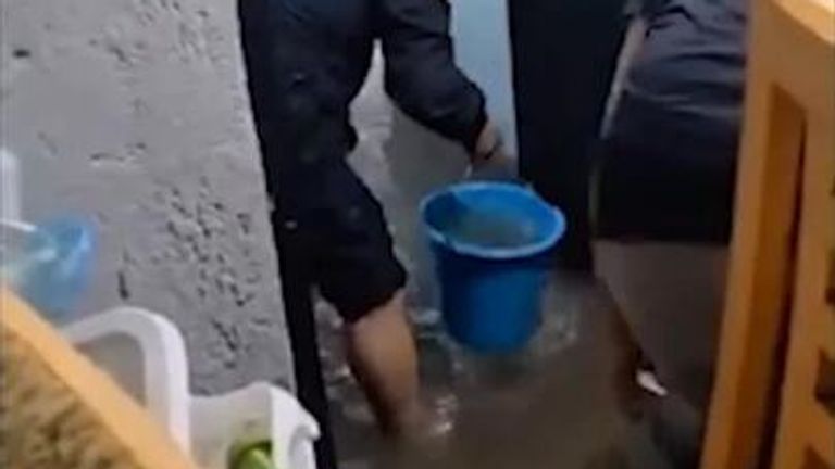 Mexico City authorities scoop water out of apartment buildings.